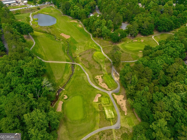 aerial view of property and surrounding area with a golf club and a nearby body of water