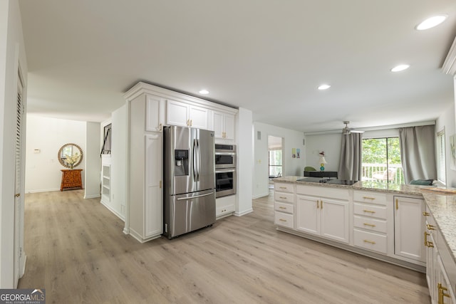 kitchen with stainless steel appliances, light wood finished floors, white cabinets, recessed lighting, and baseboards