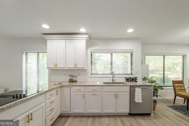 kitchen with dishwasher, a sink, light wood-style flooring, white cabinets, and recessed lighting