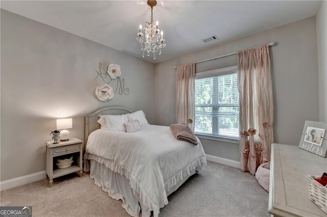 carpeted bedroom featuring a chandelier and baseboards