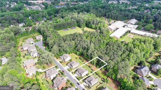 aerial view of property and surrounding area featuring property parcel outlined and nearby suburban area