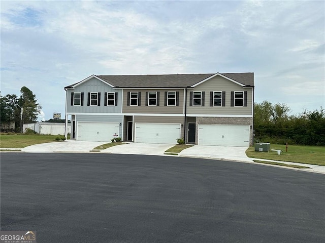 8668 Webb Rd Unit 6, Riverdale, GA 30274 - view of front facade with board and batten siding, driveway, and an attached garage