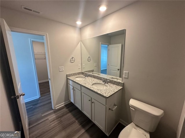 8668 Webb Rd Unit 6, Riverdale, GA 30274 - bathroom featuring wood finished floors, toilet, recessed lighting, baseboards, and double vanity