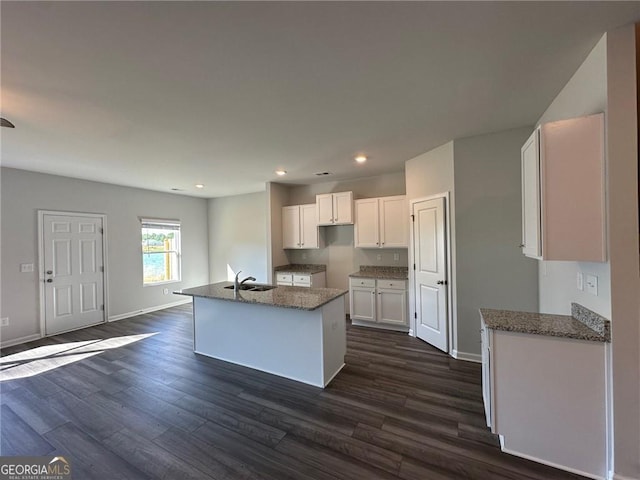 8668 Webb Rd Unit 6, Riverdale, GA 30274 - kitchen with a sink, white cabinetry, dark wood finished floors, dark stone counters, and baseboards