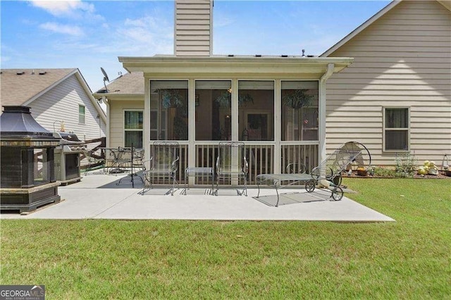 175 River Mill Ln, Dawsonville, GA 30534 - back of property with a sunroom, a patio area, a chimney, and a yard