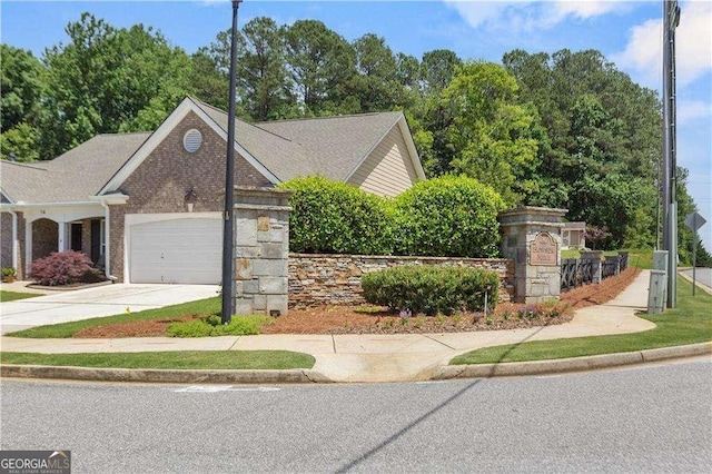 175 River Mill Ln, Dawsonville, GA 30534 - view of front of house featuring a garage, driveway, brick siding, and view of wooded area