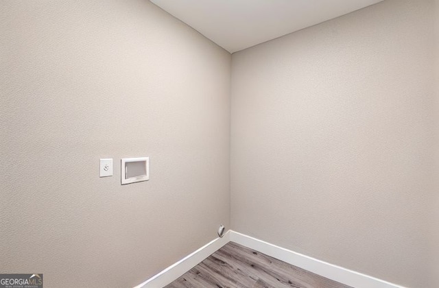 3275 Dodson Dr, East Point, GA 30344 - clothes washing area featuring baseboards, light wood-style floors, electric dryer hookup, and hookup for a washing machine