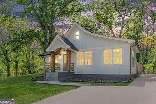 3275 Dodson Dr, East Point, GA 30344 - view of front of home featuring board and batten siding, a front yard, and crawl space