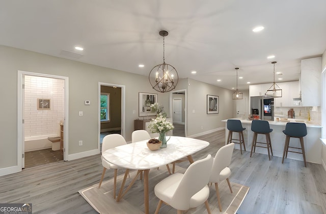 3275 Dodson Dr, East Point, GA 30344 - dining space with light wood-style floors, baseboards, recessed lighting, and a chandelier