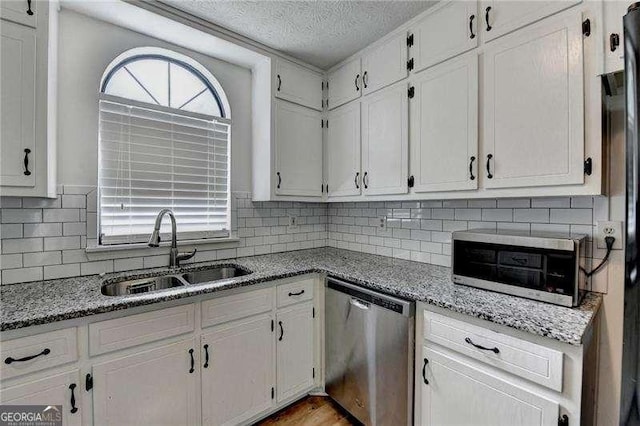 4278 Trotters Ln, Auburn, GA 30011 - kitchen featuring dishwasher, a textured ceiling, white cabinetry, and backsplash