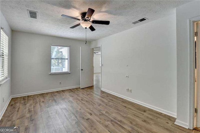 4278 Trotters Ln, Auburn, GA 30011 - unfurnished bedroom with a textured ceiling, wood finished floors, and a ceiling fan