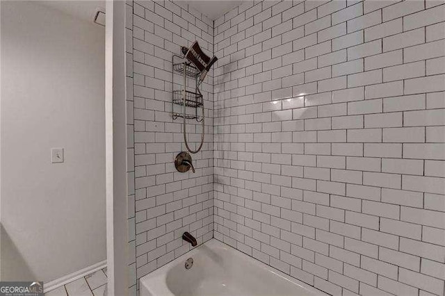full bathroom with baseboards and washtub / shower combination