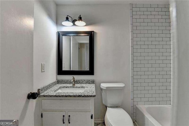 bathroom featuring toilet and vanity
