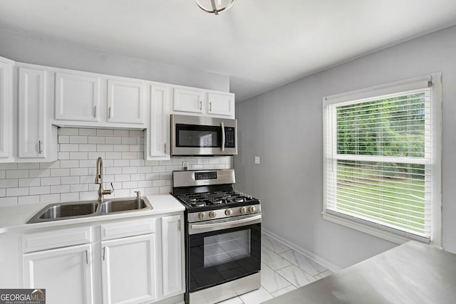 3650 Croft Pl NW, Atlanta, GA 30331 - kitchen featuring stainless steel appliances, a sink, light countertops, white cabinetry, and tasteful backsplash