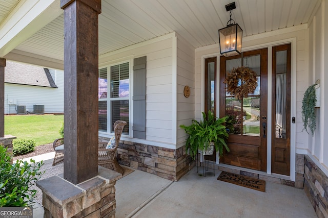 295 Graceton Farms Dr, Senoia, GA 30276 - doorway to property featuring a porch, stone siding, and central AC