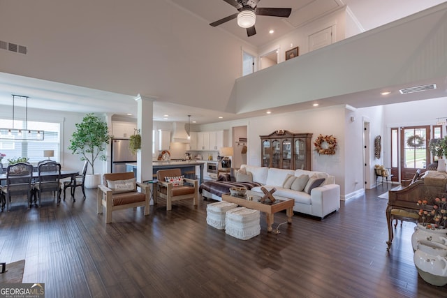 295 Graceton Farms Dr, Senoia, GA 30276 - living area featuring a ceiling fan, a towering ceiling, dark wood finished floors, baseboards, and ornamental molding