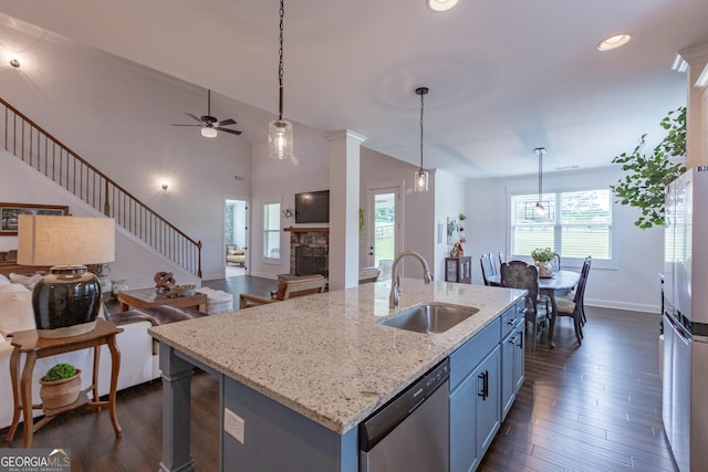 295 Graceton Farms Dr, Senoia, GA 30276 - kitchen with a sink, appliances with stainless steel finishes, open floor plan, blue cabinetry, and ceiling fan