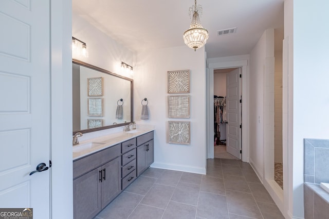 295 Graceton Farms Dr, Senoia, GA 30276 - bathroom with a chandelier, double vanity, tile patterned flooring, a walk in closet, and a tub to relax in