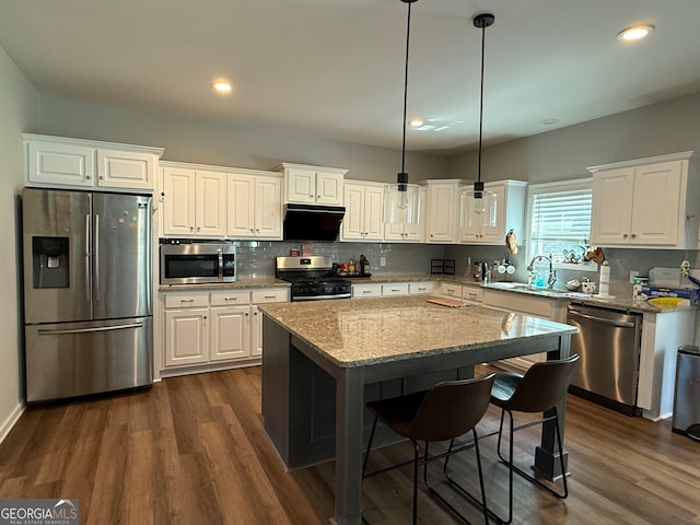 210 Fenwick Farm Dr, Lagrange, GA 30241 - kitchen with appliances with stainless steel finishes, a sink, tasteful backsplash, white cabinets, and a kitchen island