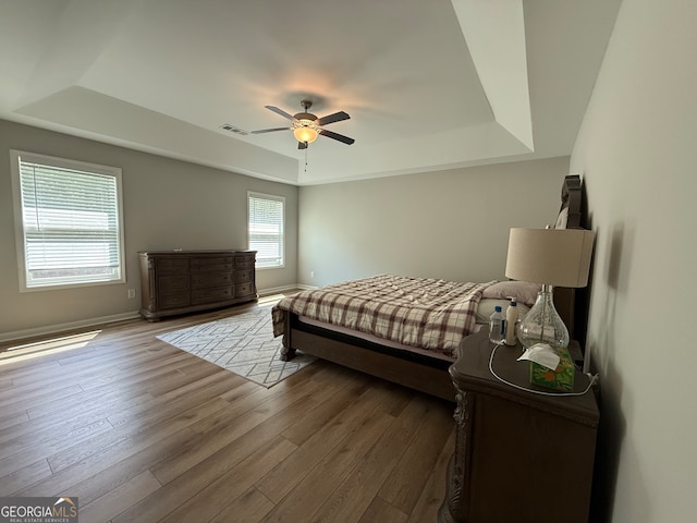 210 Fenwick Farm Dr, Lagrange, GA 30241 - bedroom with a tray ceiling, wood finished floors, baseboards, and a ceiling fan
