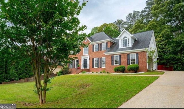 view of front of house featuring brick siding and driveway