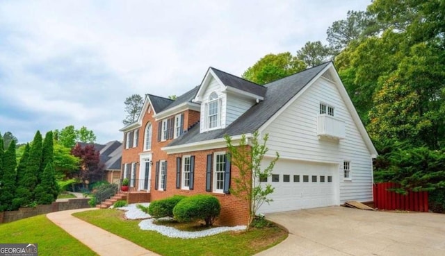 view of home's exterior featuring brick siding, driveway, fence, and a garage