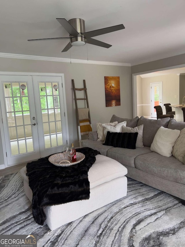 living area featuring french doors, ornamental molding, and a ceiling fan