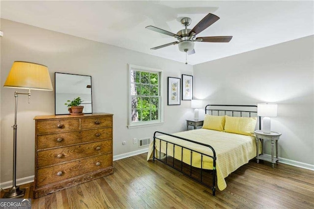 bedroom with baseboards, wood finished floors, and a ceiling fan