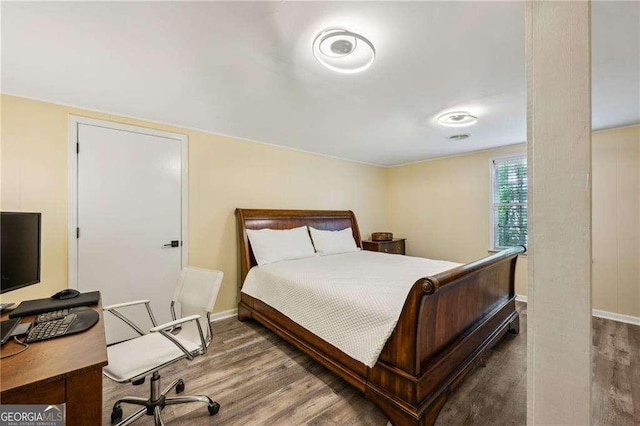 bedroom with wood finished floors and baseboards