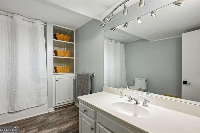 full bathroom featuring wood finished floors, toilet, vanity, and shower / bathtub combination with curtain