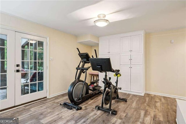 workout area with wood finished floors and baseboards
