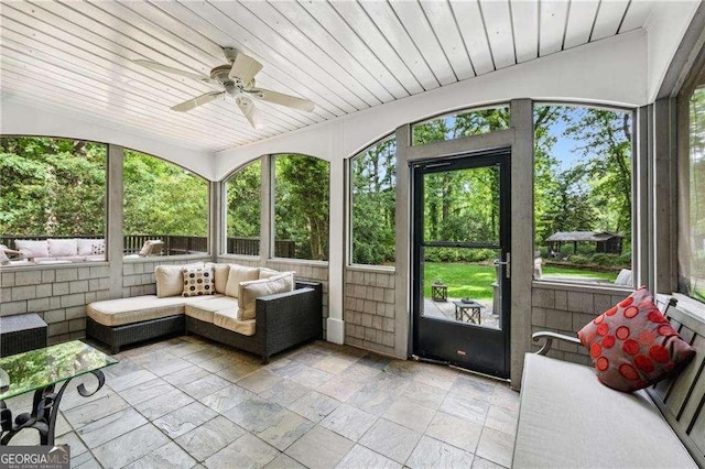 sunroom / solarium with a ceiling fan and outdoor lounge area