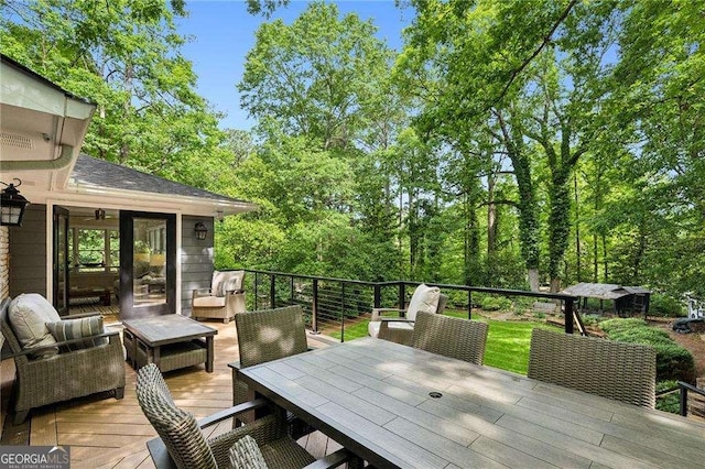 wooden terrace with outdoor dining area