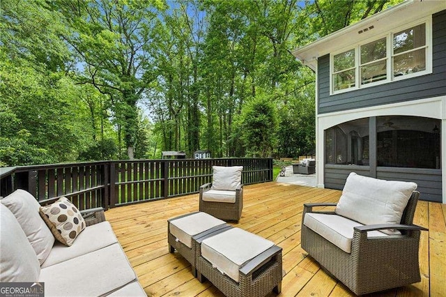 wooden terrace with view of wooded area