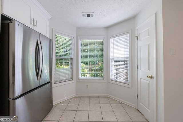 3350 Serenade Ct, Alpharetta, GA 30004 - kitchen featuring freestanding refrigerator, baseboards, white cabinetry, a textured ceiling, and light tile patterned flooring