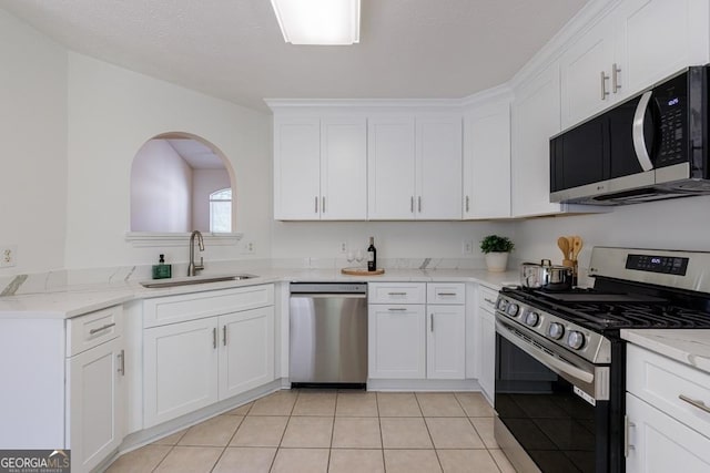 3350 Serenade Ct, Alpharetta, GA 30004 - kitchen with stainless steel appliances, a sink, white cabinets, light tile patterned flooring, and light stone counters
