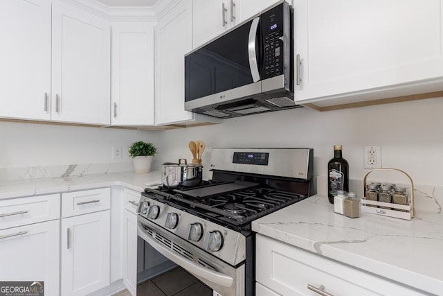 3350 Serenade Ct, Alpharetta, GA 30004 - kitchen featuring appliances with stainless steel finishes, white cabinetry, and light stone counters