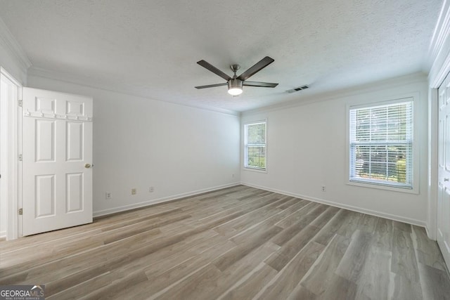 3350 Serenade Ct, Alpharetta, GA 30004 - unfurnished bedroom featuring light wood finished floors, crown molding, baseboards, a textured ceiling, and a ceiling fan