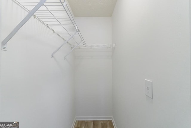3350 Serenade Ct, Alpharetta, GA 30004 - walk in closet featuring wood finished floors