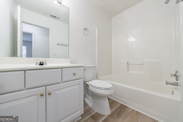 3350 Serenade Ct, Alpharetta, GA 30004 - full bathroom featuring wood finished floors, toilet, vanity, and washtub / shower combination
