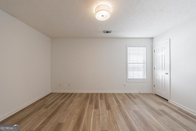 3350 Serenade Ct, Alpharetta, GA 30004 - unfurnished room with light wood-style flooring, a textured ceiling, and baseboards