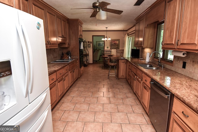 kitchen featuring white refrigerator with ice dispenser, a sink, dishwasher, decorative backsplash, and a ceiling fan