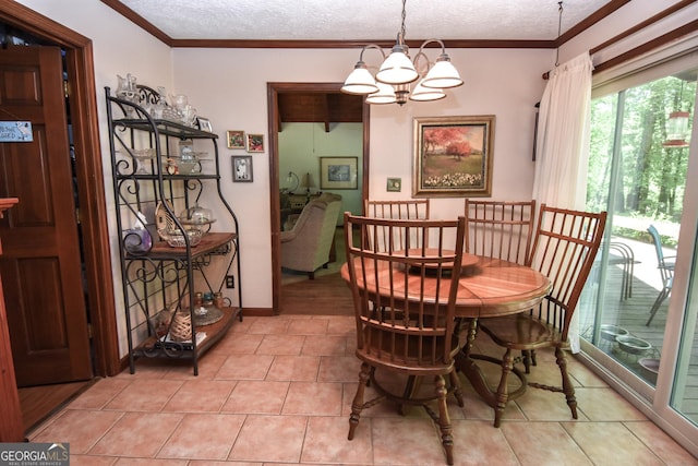 dining space with a textured ceiling, a chandelier, light tile patterned flooring, and crown molding
