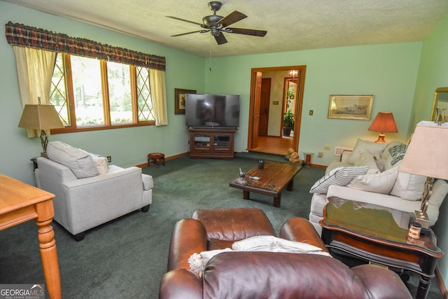 living area featuring ceiling fan, carpet, baseboards, and a textured ceiling