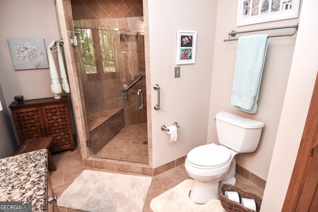 full bath featuring baseboards, toilet, a stall shower, and tile patterned flooring