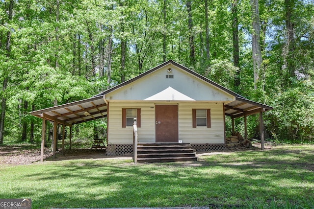 view of front facade with a front yard and a carport