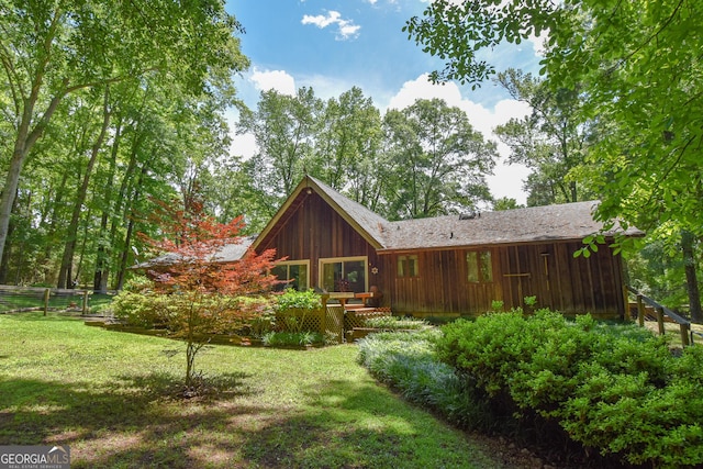 rear view of property featuring a yard