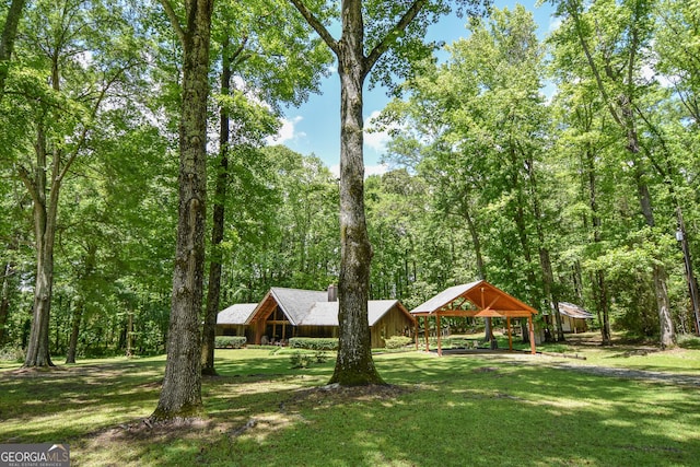 view of green lawn featuring a detached carport