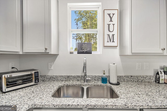 278 Lambert Overlook Cir, Carrollton, GA 30117 - kitchen featuring a sink, plenty of natural light, white cabinetry, and light stone countertops