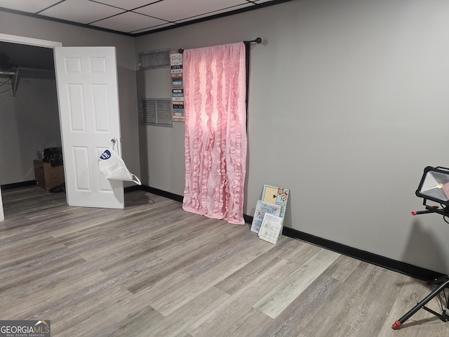 605 Smithville Church Rd, Warner Robins, GA 31088 - unfurnished bedroom featuring wood finished floors, baseboards, and a drop ceiling